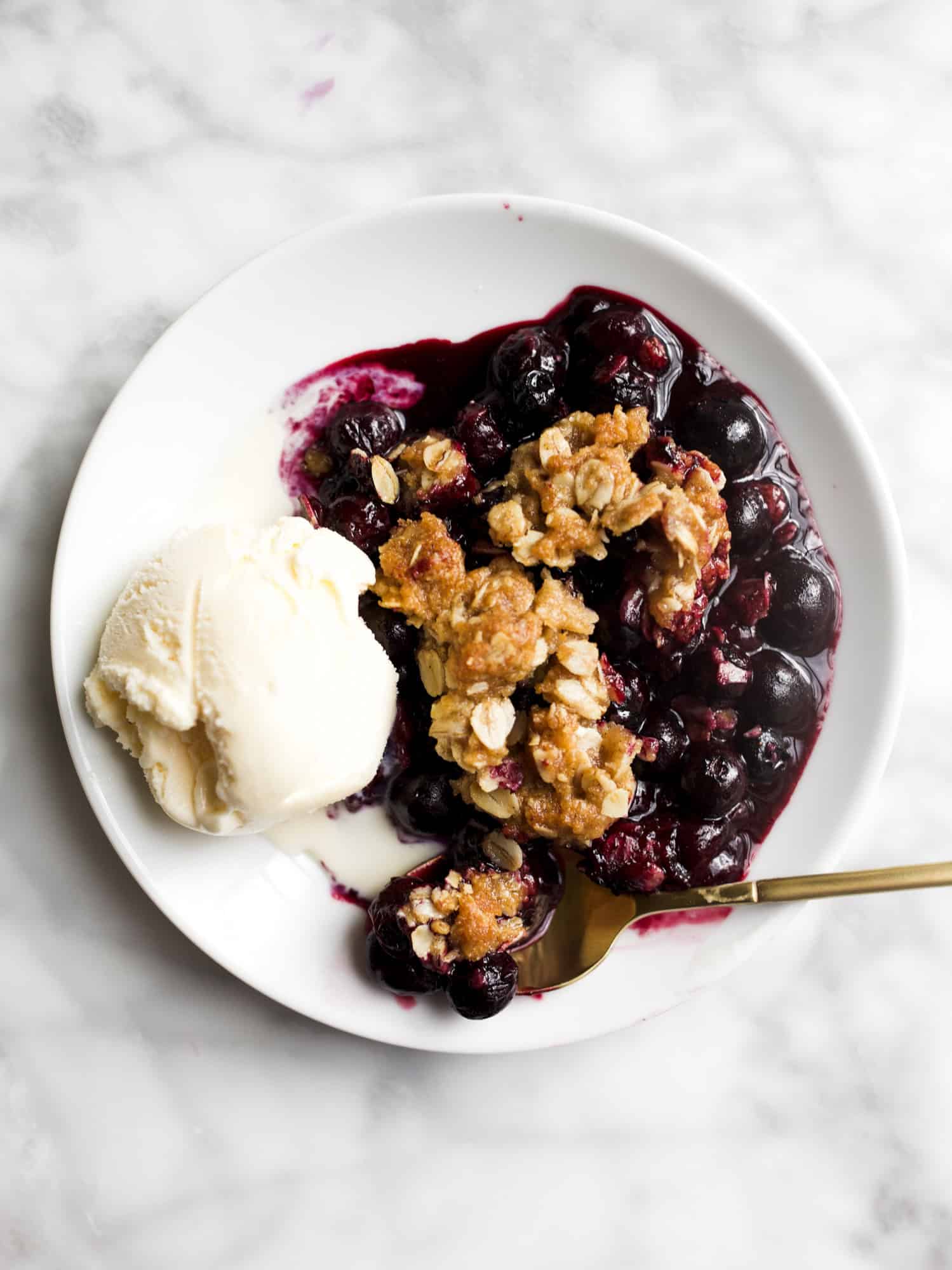 Small Batch Blueberry Crisp by Wood and Spoon Blog. This is a simple summer fruit recipe using fresh blueberries and a brown sugar oat crumble topping. You can make this with fresh or frozen blueberries, and the recipe yields enough for a single family. This easy blueberry dessert is a quick option for summer and is best served with vanilla ice cream. Learn how to make it on thewoodandspoon.com