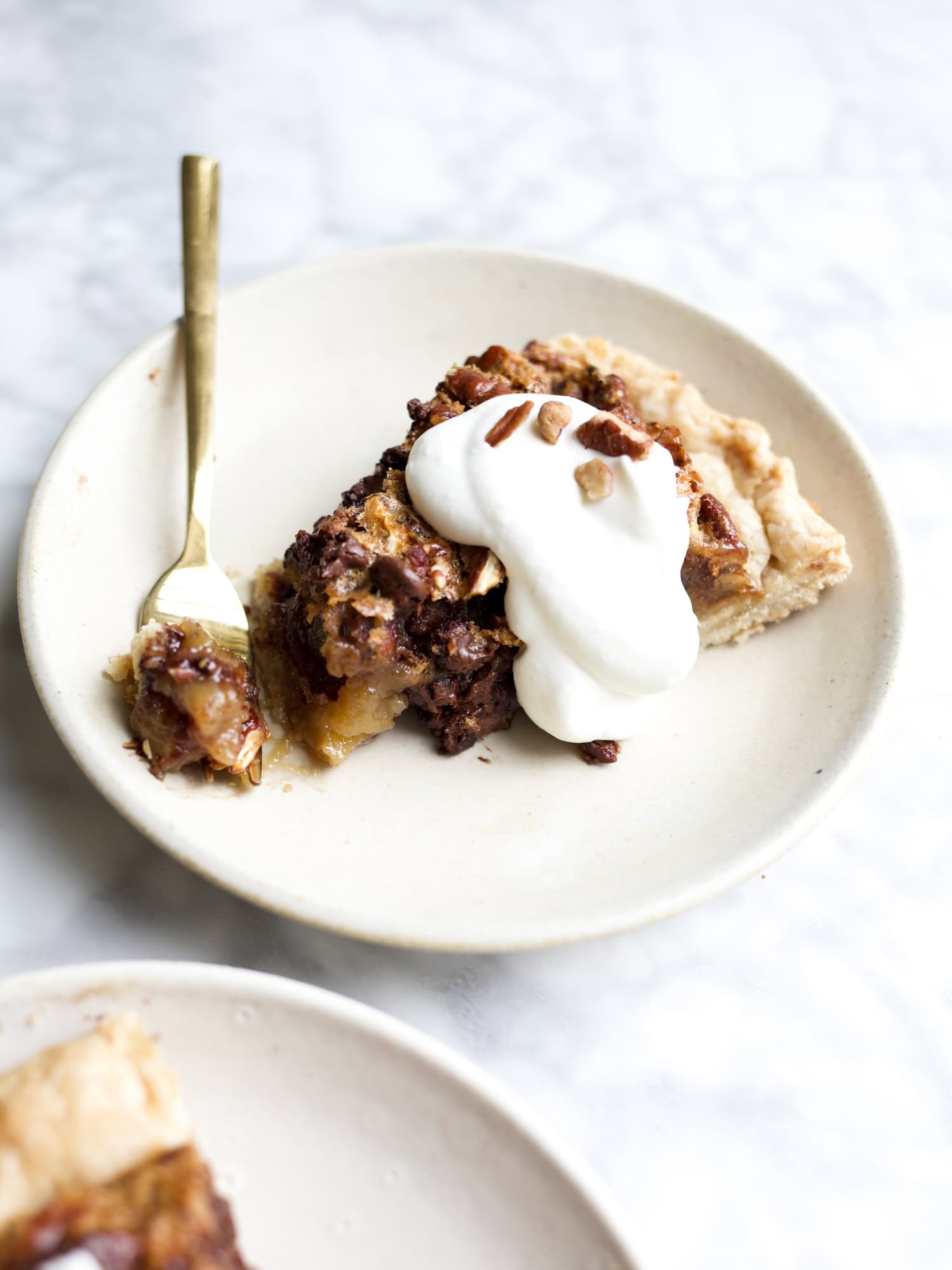 Bourbon Chocolate Pecan Pie by Wood and Spoon blog. This is a gooey pecan pie with a butter crisp crust, chocolate chips, and a splash of bourbon for flavor. This is the perfect alternative for traditional pecan pie. This pie is sweet and salty and a holiday dessert for bourbon lovers. Find the recipe and how to on thewoodandspoon.com .
