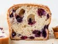 Blueberry Brioche recipe by Wood and Spoon blog. This is a recipe for two yeast loaves of brioche made with butter, egg, and a smidge of sugar. The fluffy white bread is studded with blueberries and seasoned with cinnamon. Each loaf has an optional crumble topping for extra sweet and salty in each bite. Learn how to fold and create this beautiful homemade breakfast treat here at thewoodandspoon.com by Kate Wood.