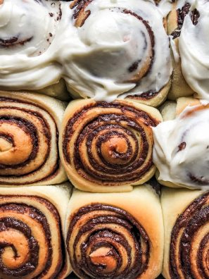 Chocolate Sweet Rolls Recipe by Kate Wood of The Wood and Spoon Blog. This recipe makes two pans of fluffy cinnamon buns filled with a chocolate and espresso swirl filling. A cream cheese glaze frosting finishes off these perfect breakfast treats. The dough is similar to a brioche style dough as it contains a bit of sugar, milk and eggs. This is a yeast roll. They make a great holiday brunch item , treat, or dessert. Find the recipe and the how to on thewoodandspoon.com