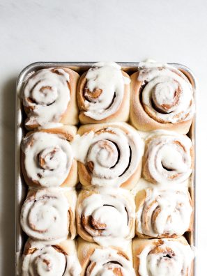 Overnight Cinnamon Rolls by Wood and Spoon. These are fluffy brown sugar and spice morning buns topped with a cream cheese frosting. The yeast dough can be prepped ahead of time, rolled, and left to rest in the fridge until baking time the following morning. This recipe makes delicious breakfast treats a cinch and is perfect for holiday entertaining. Find the recipe and how to for these pastries on thewoodandspoon.com by Kate Wood