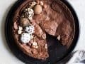 Flourless Chocolate Cake recipe by Wood and Spoon. This is a fudgy meringue cake flavored with espresso. It has a fallen sunken top from the egg whites and a flaky top with gooey center. Topped with cocoa powder, powdered sugar, or loads of decor, this cake is as beautiful as it is delicious. Perfect for the ultra rich chocolate lover in your life or for valentines day! Find the recipe and how to on thewoodandspoon.com