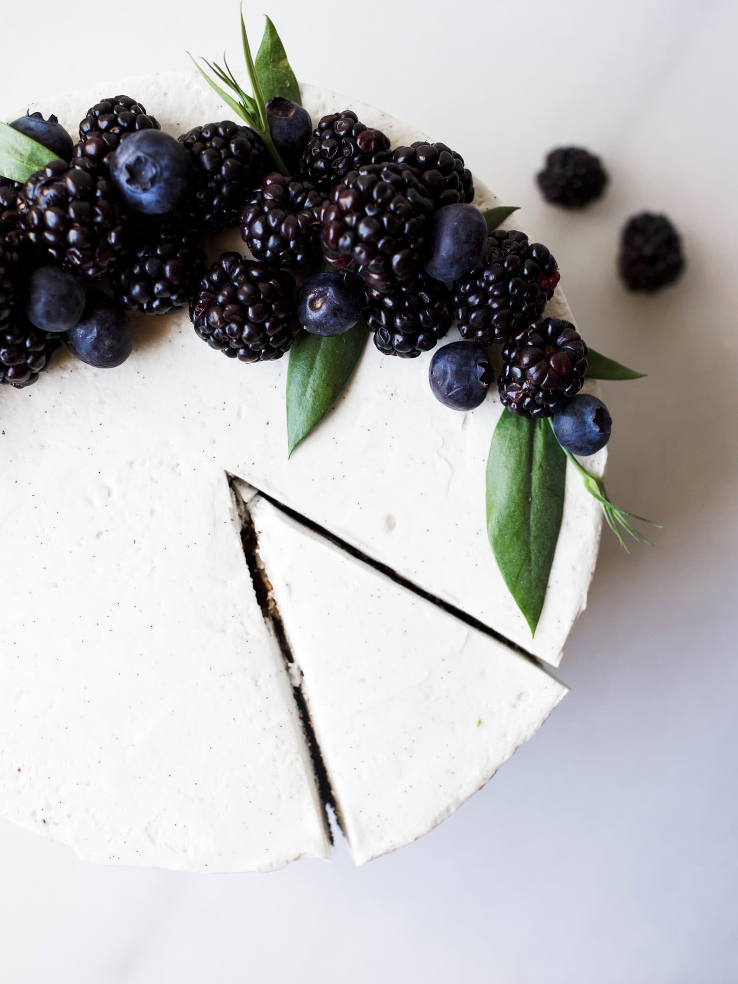 Black and White Cake By Wood and Spoon Blog by Kate Wood. This is a dark chocolate cocoa powder cake, made in one bowl, layered with a cooked flour vanilla bean frosting and a blackberry and dark chocolate ganache. This is a layer cake that is stunning and can even be used as a party/ wedding cake. The berry ganache is made with jam and cream. The cake is moist and fluffy, incredibly simple, and the frosting and smooth, light, and creamy cloud like. Find the recipe and the how to on thewoodandspoon.com
